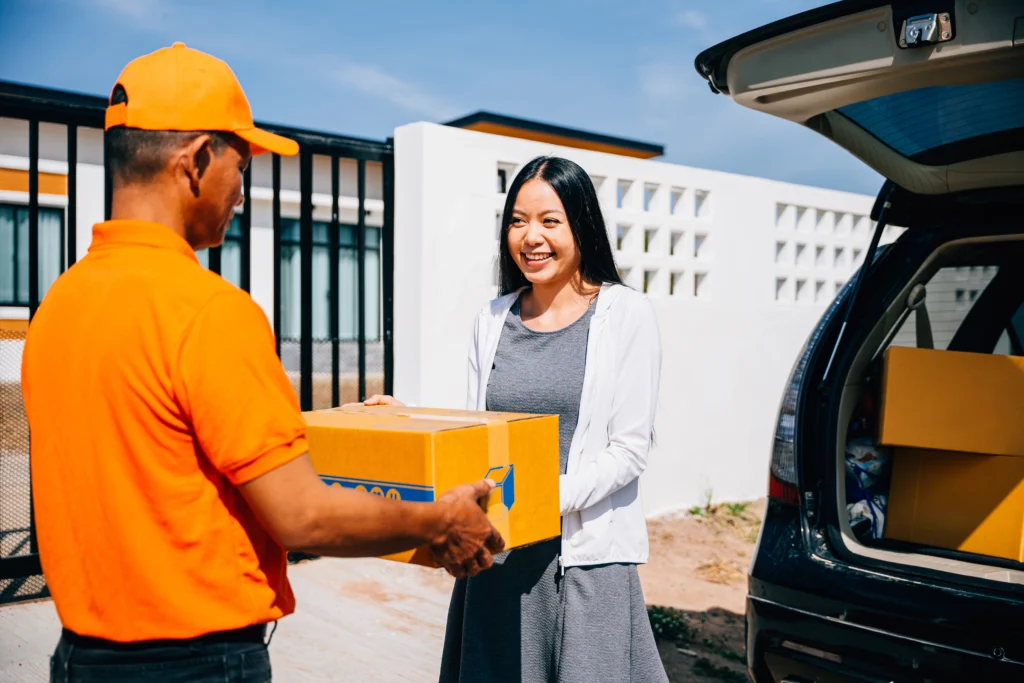 Delivery person handing over package to customer.